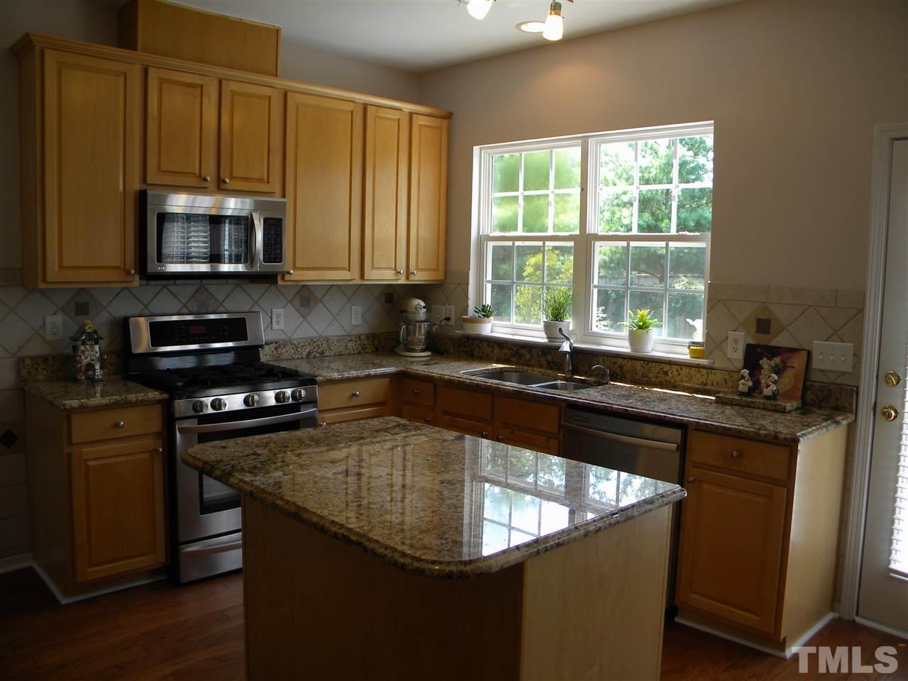 108 Rock River Road Morrisville, NC 27560 - Photo 2 of 25 a kitchen with stainless steel appliances granite countertop a sink stove and microwave