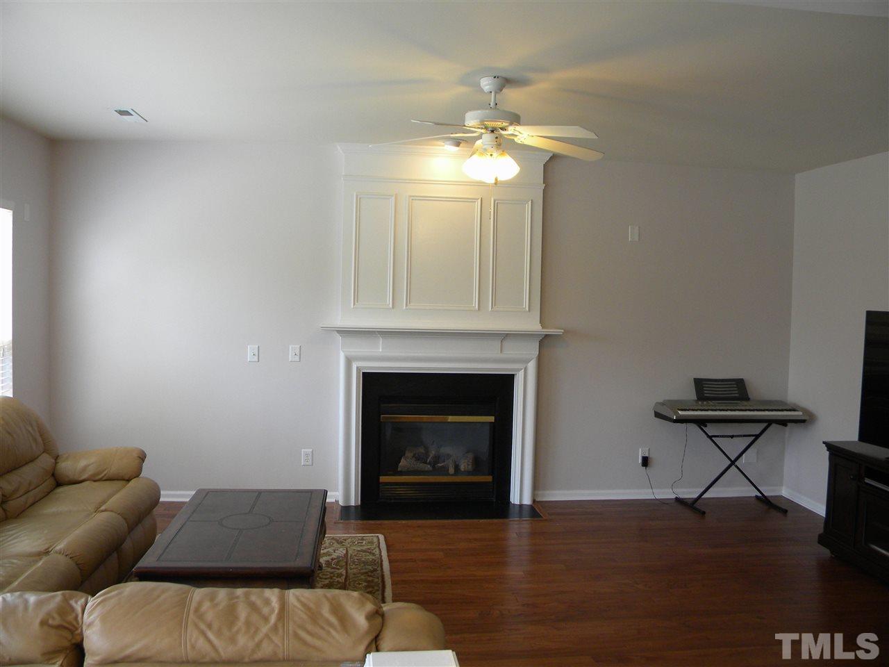 108 Rock River Road Morrisville, NC 27560 - Photo 11 of 25 a living room with furniture and a fireplace