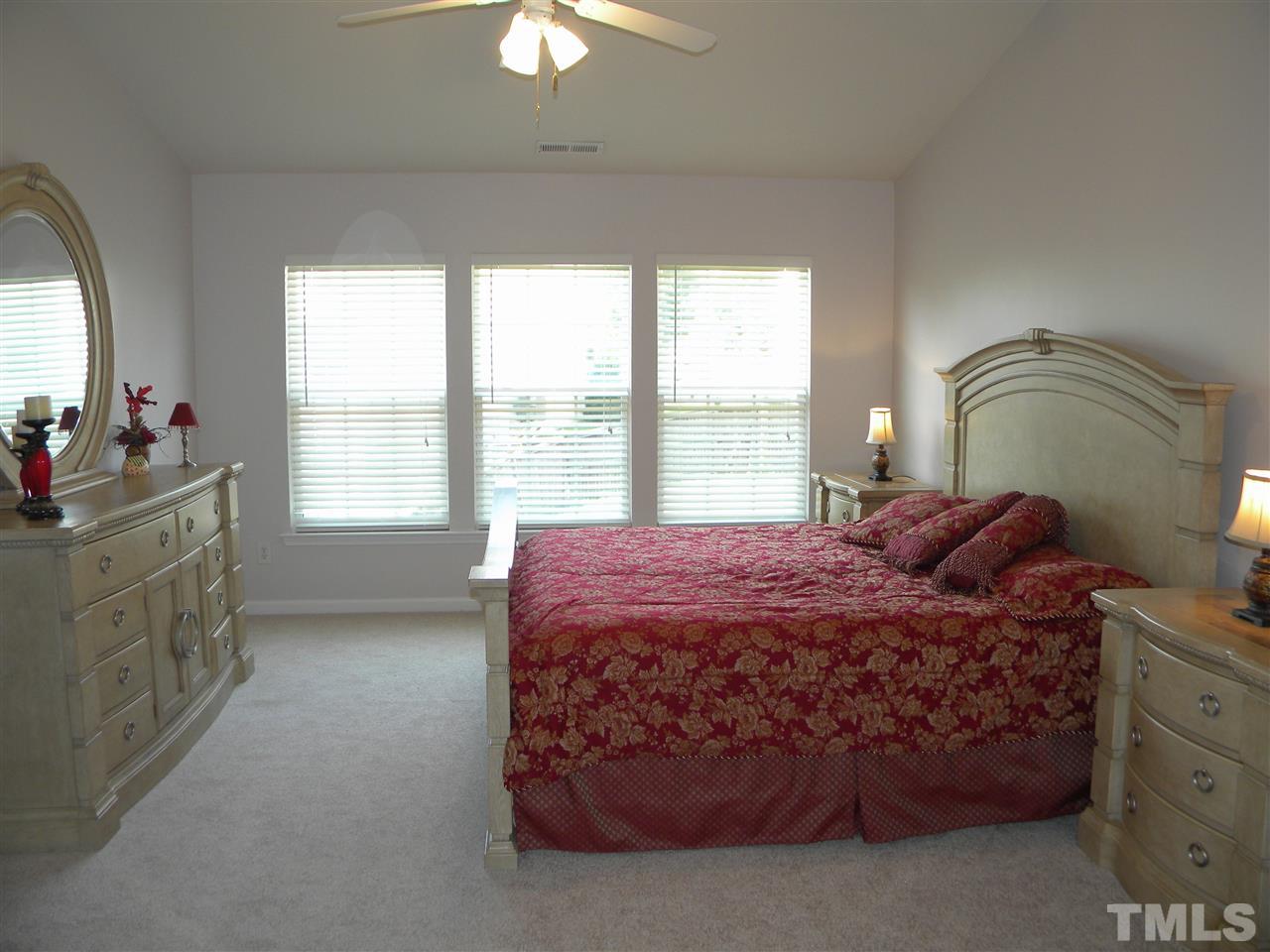 108 Rock River Road Morrisville, NC 27560 - Photo 13 of 25 a bed sitting in a bedroom next to a window