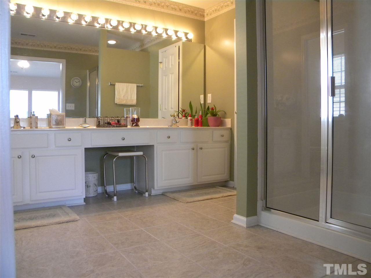 108 Rock River Road Morrisville, NC 27560 - Photo 15 of 25 a room with a mirror and a sink