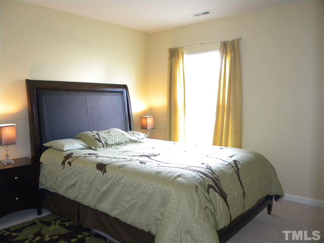 108 Rock River Road Morrisville, NC 27560 - Photo 18 of 25 a bed sitting in a bedroom next to a window