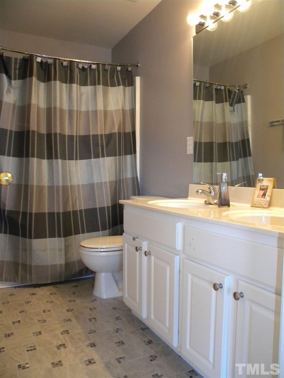 108 Rock River Road Morrisville, NC 27560 - Photo 19 of 25 a bathroom with a sink a toilet and shower