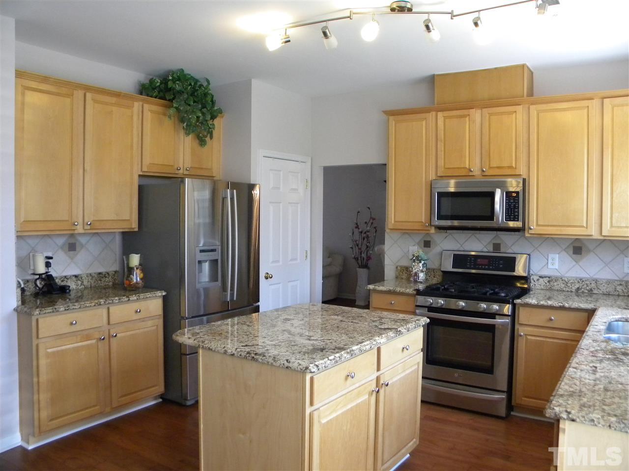 108 Rock River Road Morrisville, NC 27560 - Photo 3 of 25 a kitchen with a stove a sink and a refrigerator