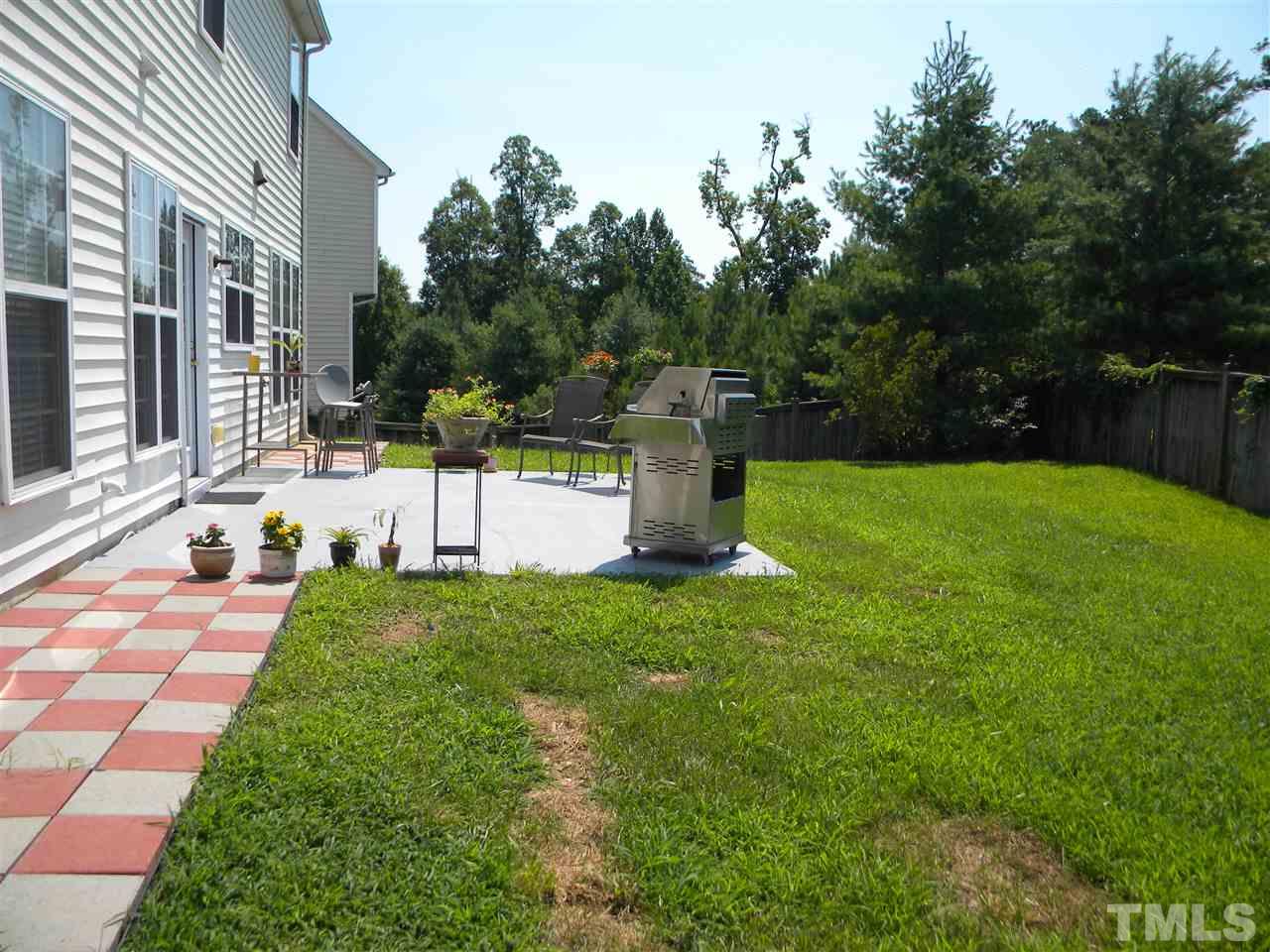 108 Rock River Road Morrisville, NC 27560 - Photo 22 of 25 a view of a backyard with a garden