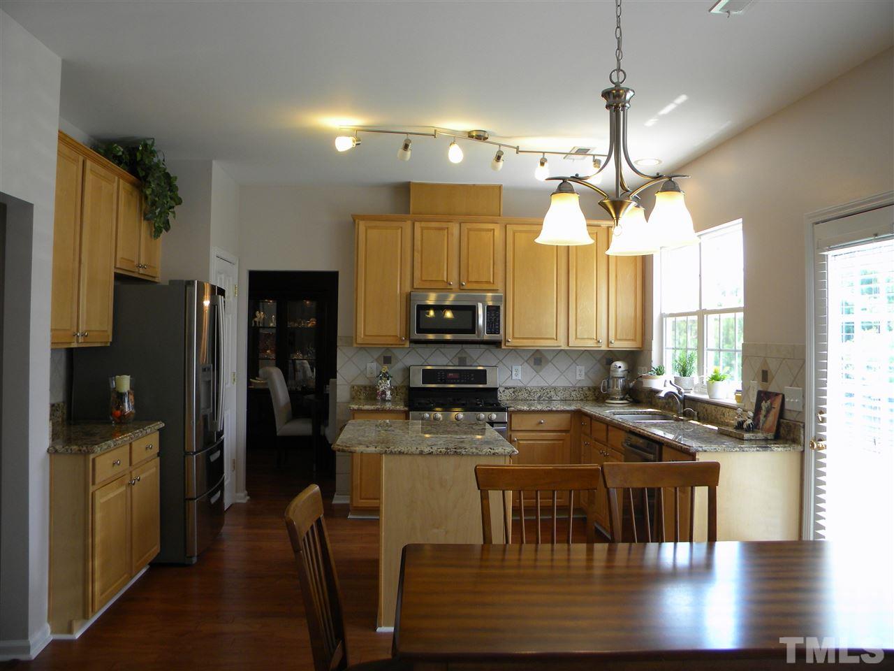 108 Rock River Road Morrisville, NC 27560 - Photo 4 of 25 a kitchen with a table chairs refrigerator and microwave