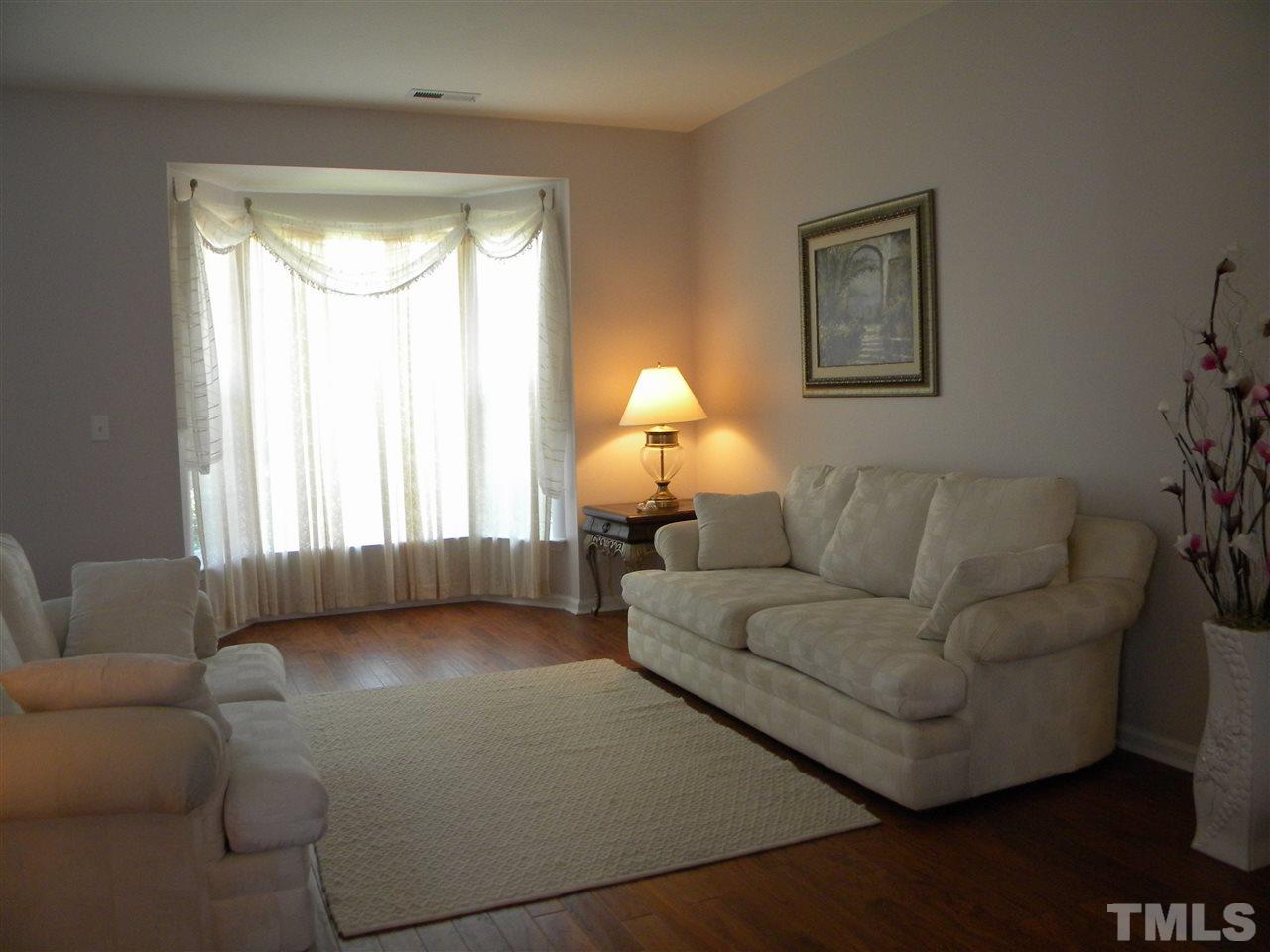 108 Rock River Road Morrisville, NC 27560 - Photo 6 of 25 a living room with furniture and a large window