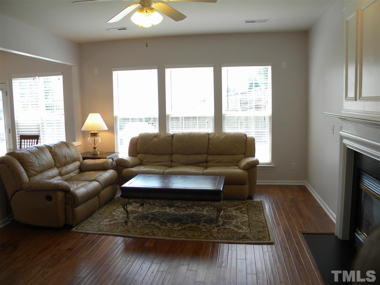 108 Rock River Road Morrisville, NC 27560 - Photo 10 of 25 a living room with furniture and a fireplace