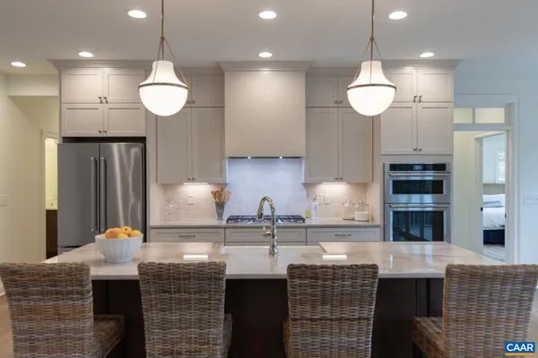 a bedroom with a large bed and large windows