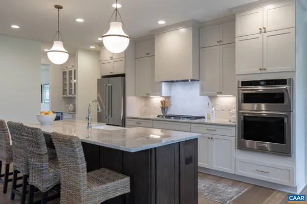 a en suite bathroom with a double vanity sink a mirror and a shower