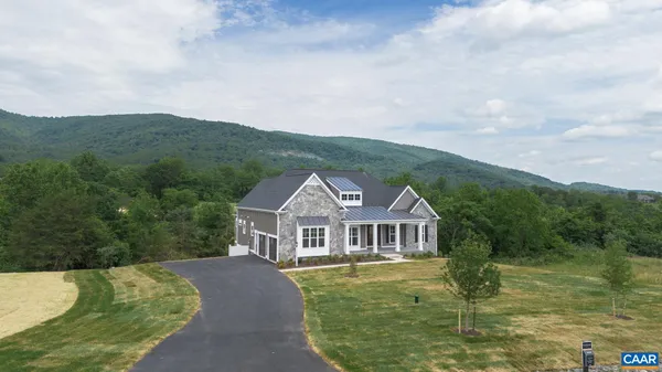 a front view of a house with a yard balcony and swimming pool