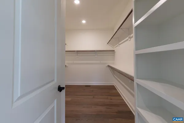 a view of a dining room with furniture a chandelier and wooden floor