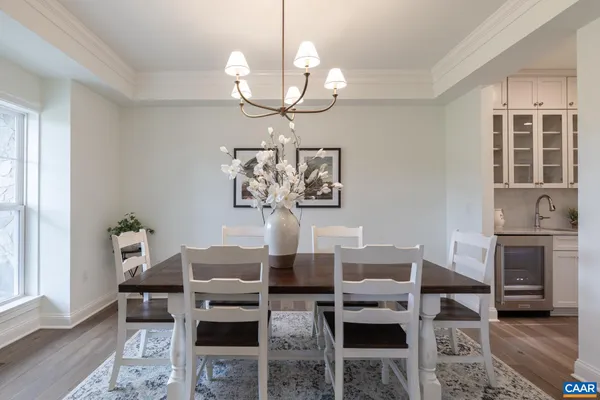 a bathroom with a toilet a sink a mirror a window and vanity