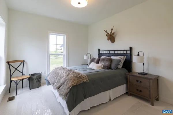 a living room with furniture and large windows