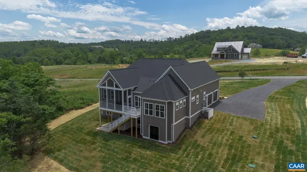 a living room with furniture wooden floor and large window
