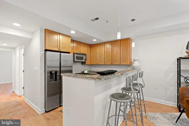 a kitchen with stainless steel appliances granite countertop a stove a refrigerator and a refrigerator