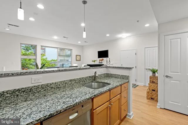 a kitchen with kitchen island granite countertop a sink and counter space