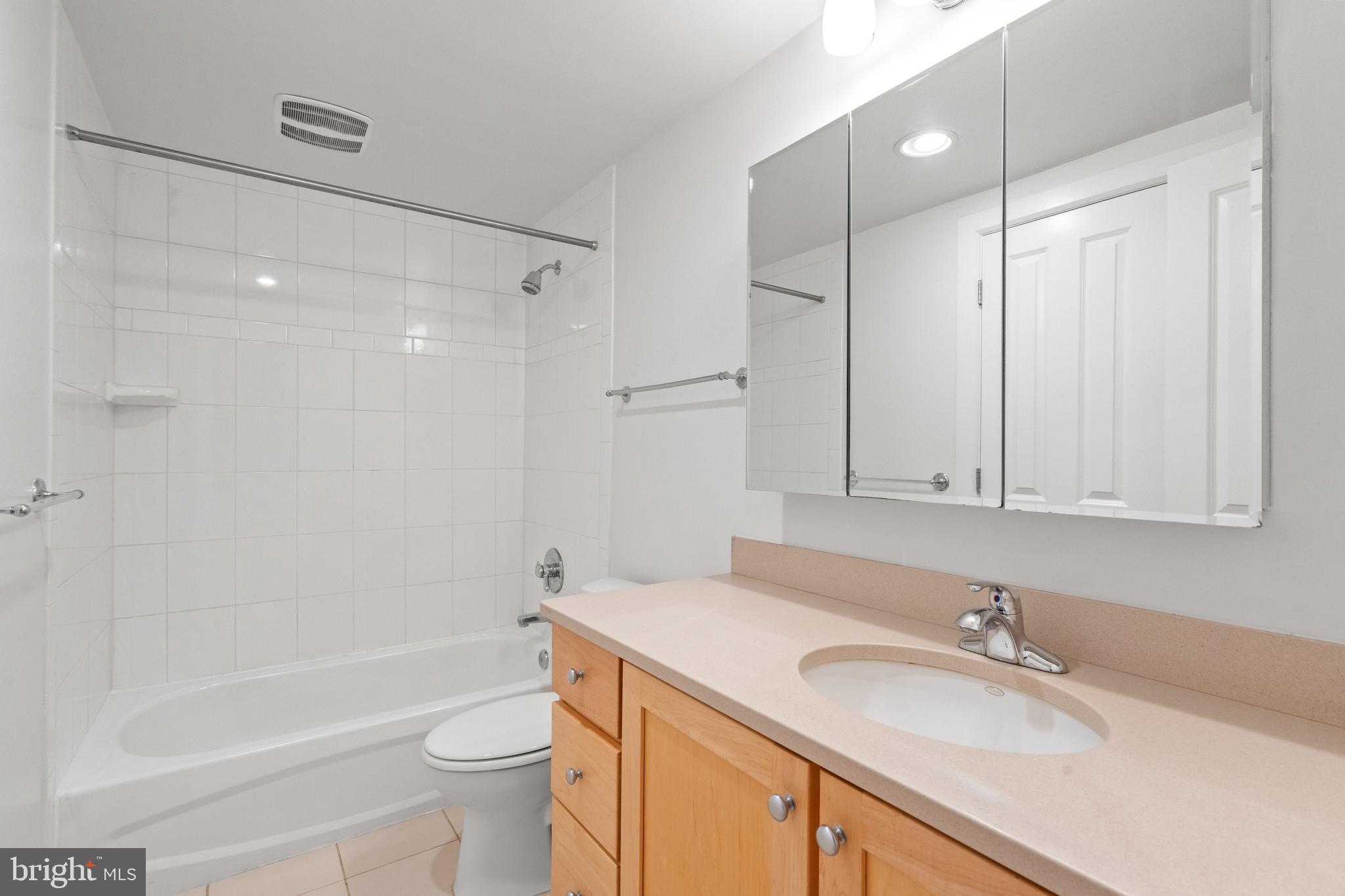 1421 Chapin Street Northwest, Unit 102 Washington, DC 20009 - Photo 17 of 37 a bathroom with a sink a toilet and a bathtub