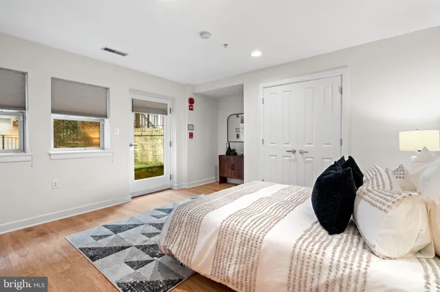 a bedroom with a bed and wooden floor