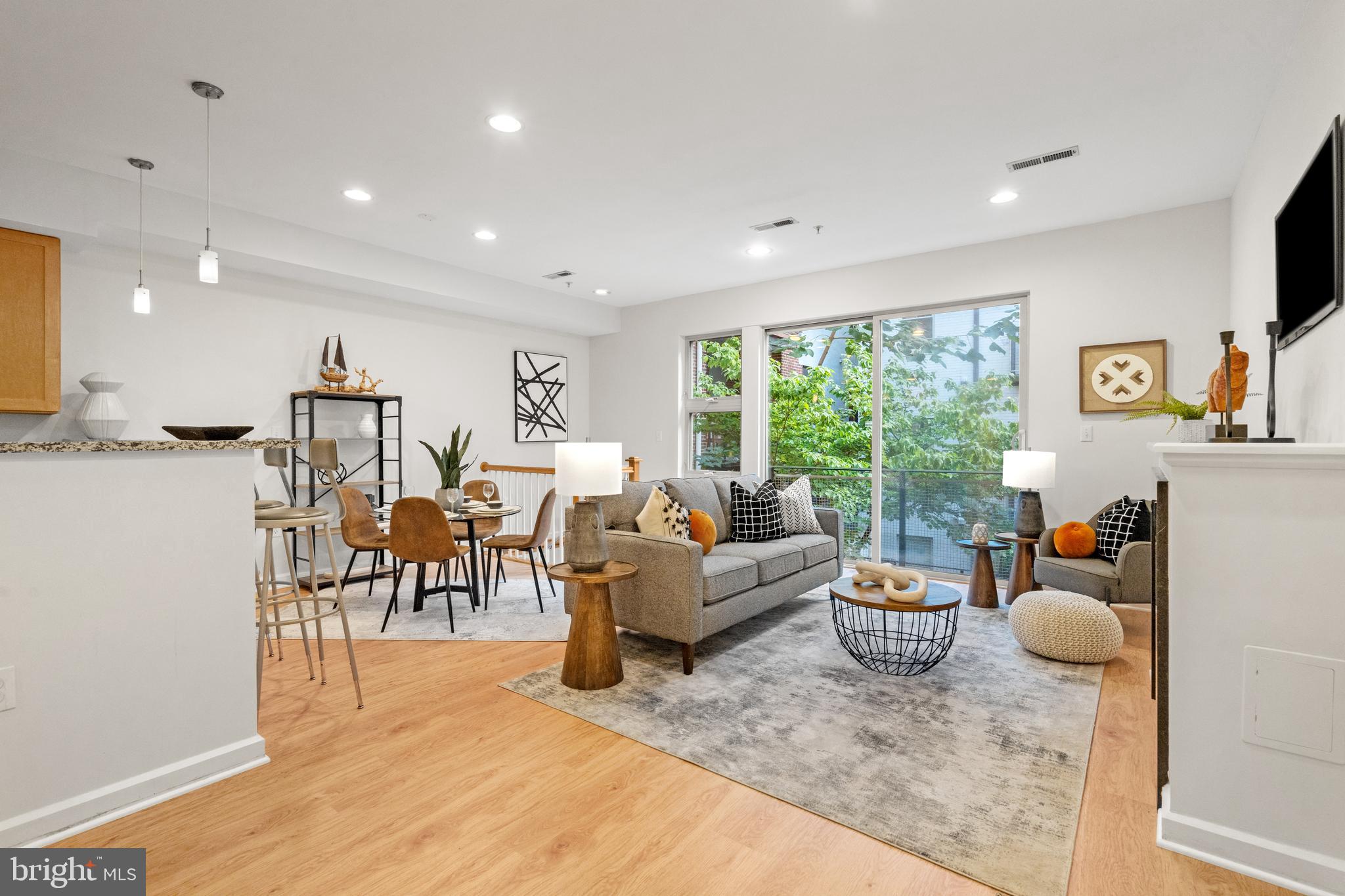1421 Chapin Street Northwest, Unit 102 Washington, DC 20009 - Photo 2 of 37 a living room with furniture and a large window