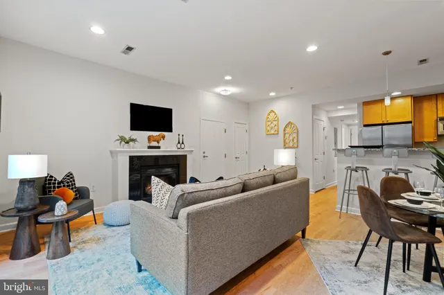 a living room with furniture and a fireplace
