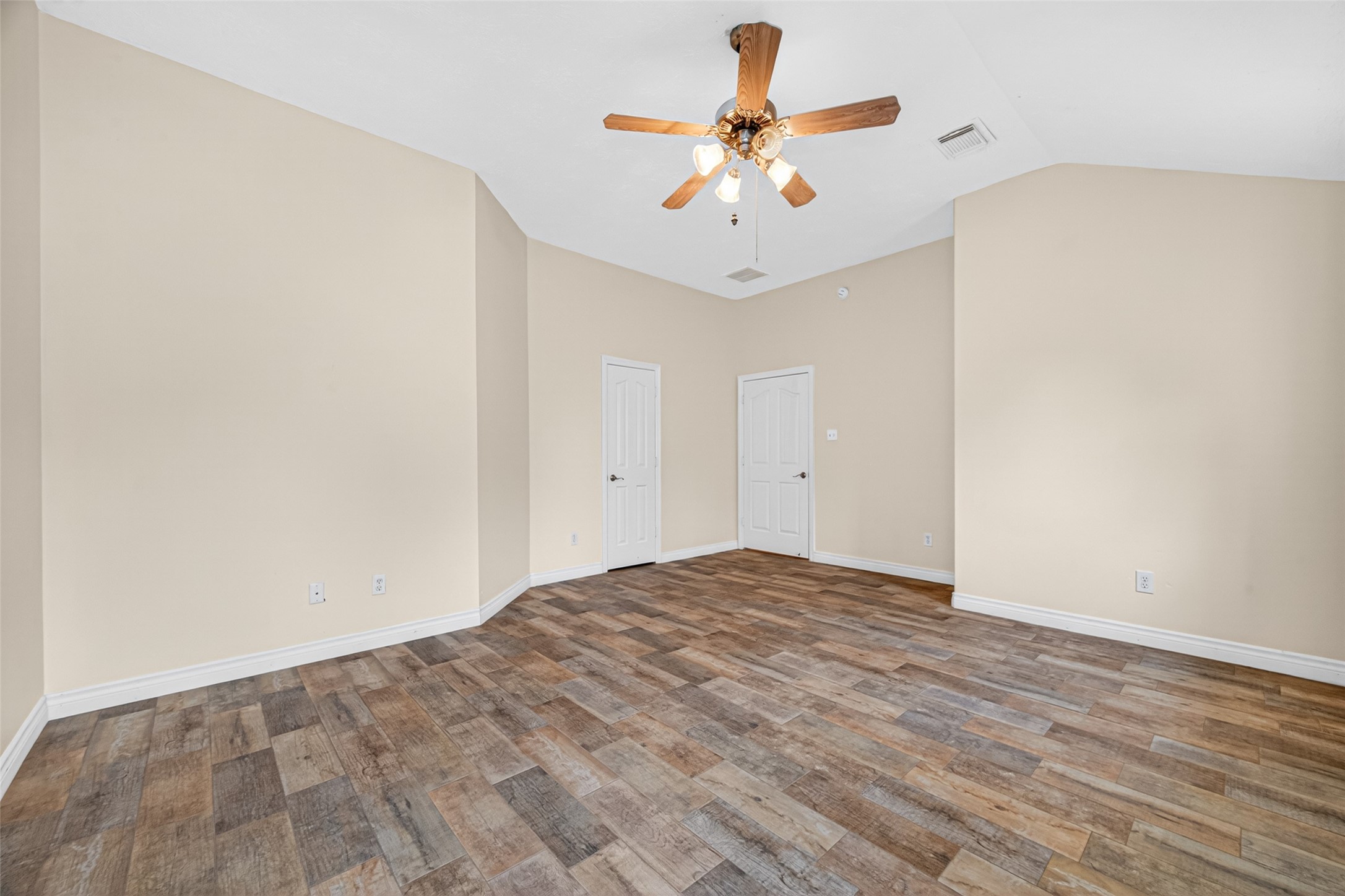 23914 Glengate Drive Spring, TX 77373 - Photo 19 of 49 an empty room with a chandelier fan and wooden floor