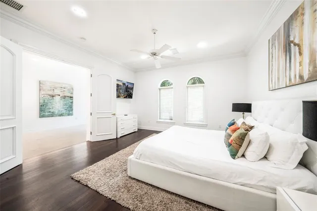 a bedroom with a white bed and white walls