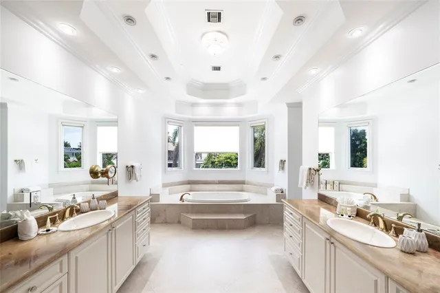 a large white kitchen with a large window