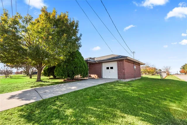 a big yard with table and chair under an umbrella