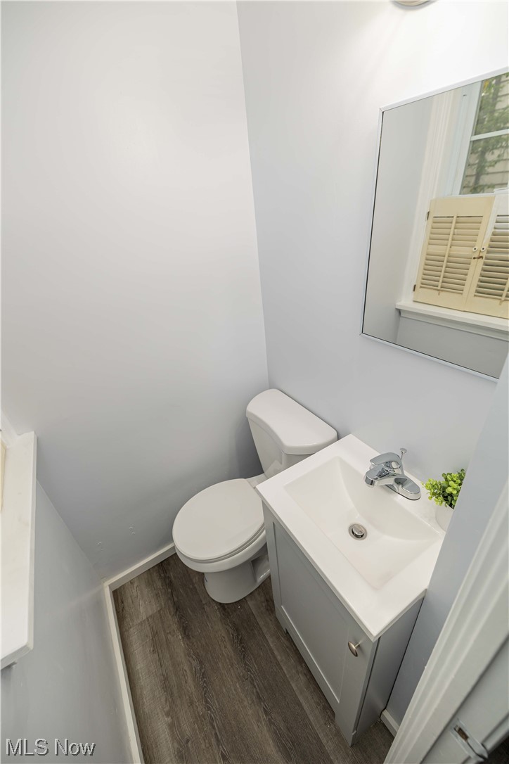 4591 Birchwold Road South Euclid, OH 44121 - Photo 12 of 35 Main floor Half Bathroom with hardwood / wood-style floors, toilet, and vanity