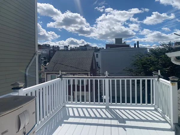 a view of a balcony with wooden fence
