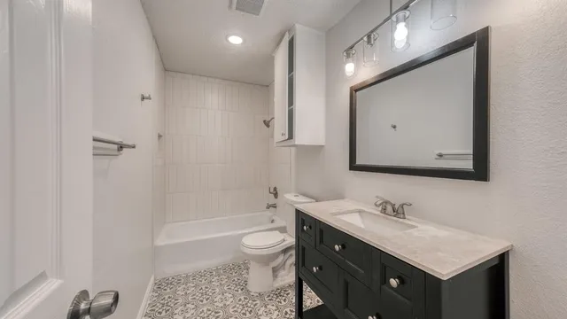 a bathroom with a sink toilet a mirror and shower