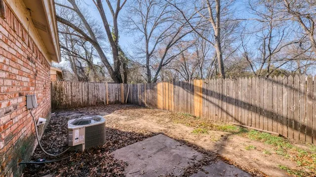 a view of a backyard with wooden fence