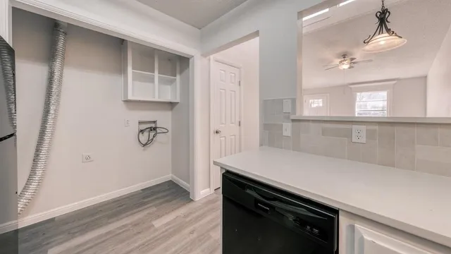 an empty room with wooden floor and cabinet