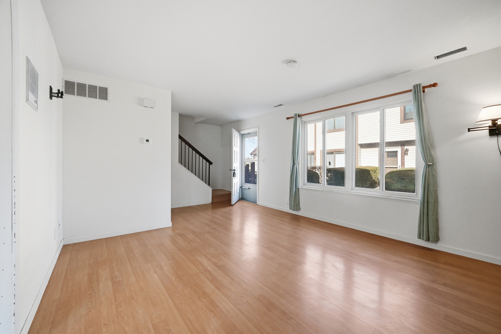 1729 Cedarbrook Court Sycamore, IL 60178 - Photo 12 of 36 a view of an empty room with wooden floor and a window