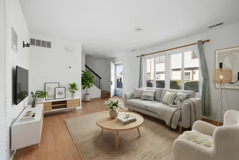 a view of a dining room with furniture a chandelier and wooden floor