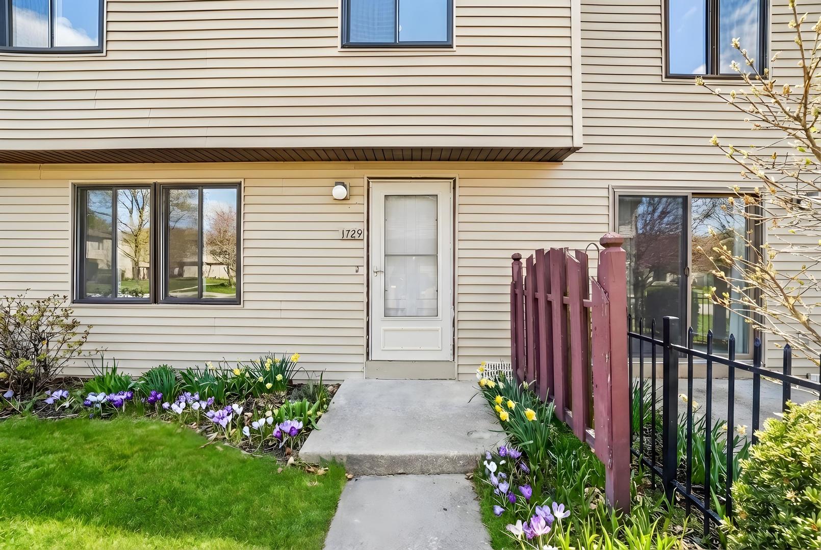 1729 Cedarbrook Court Sycamore, IL 60178 - Photo 2 of 36 a front view of a house with a garden