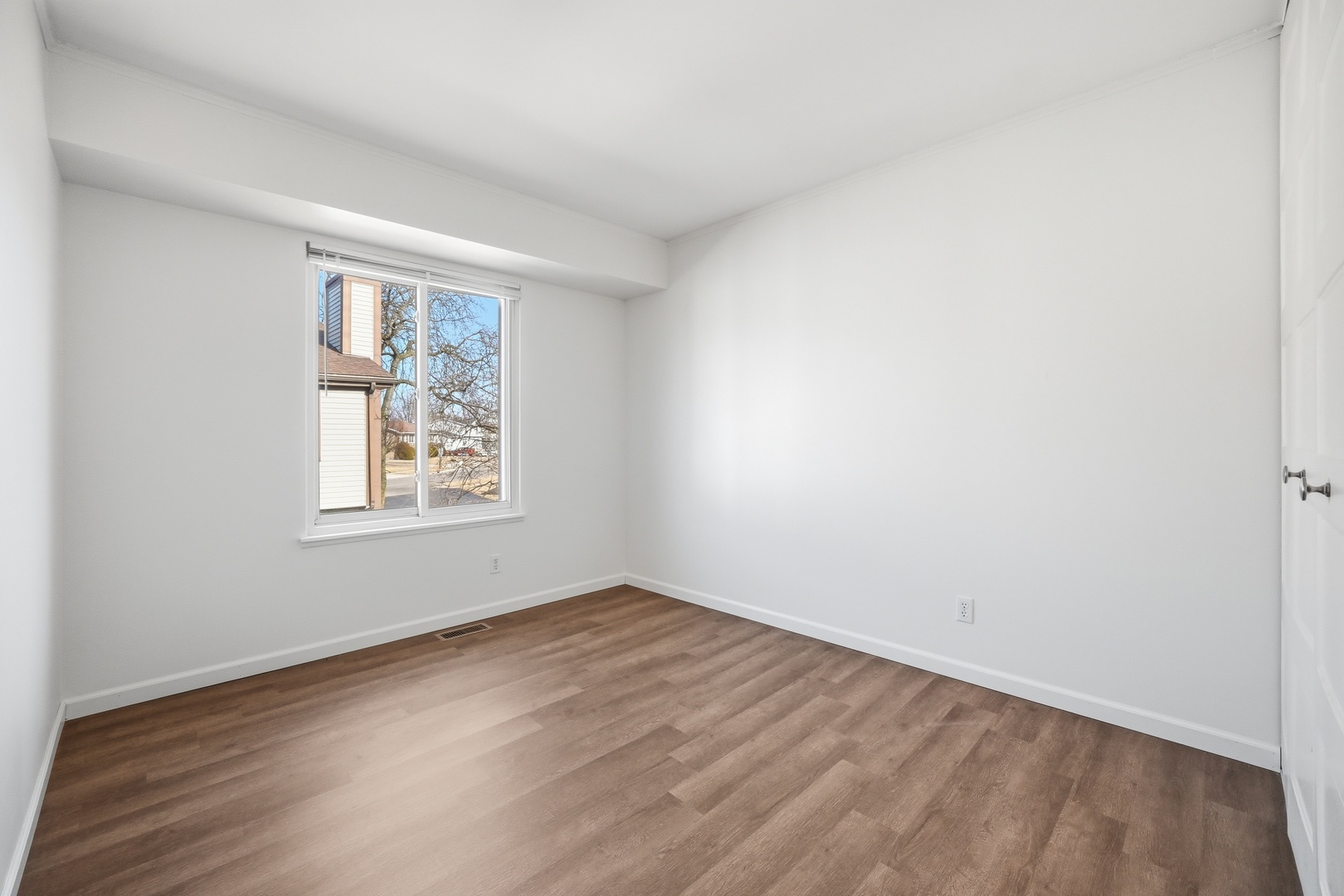 1729 Cedarbrook Court Sycamore, IL 60178 - Photo 27 of 36 an empty room with wooden floor and windows