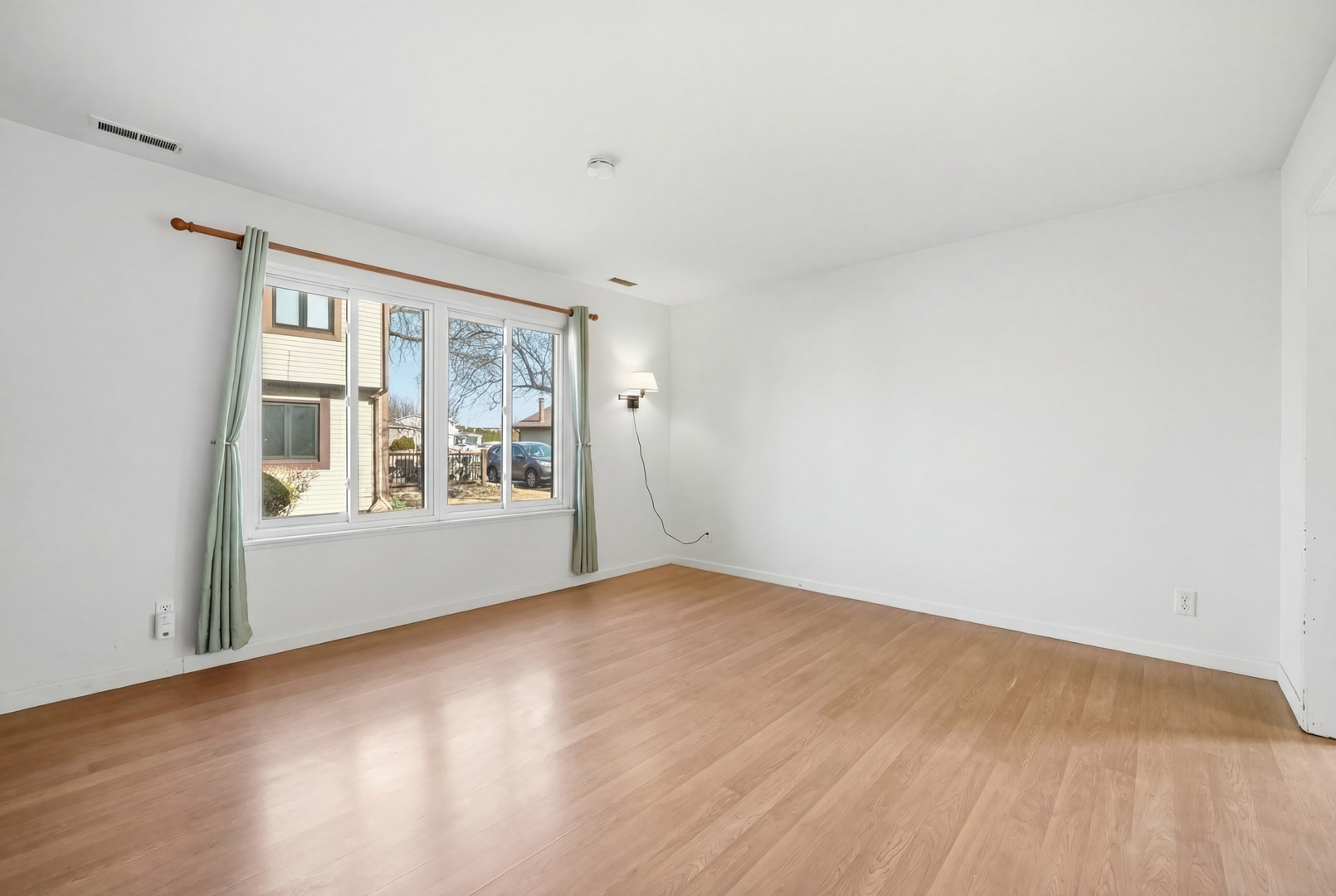 1729 Cedarbrook Court Sycamore, IL 60178 - Photo 10 of 36 a view of an empty room with wooden floor and a window