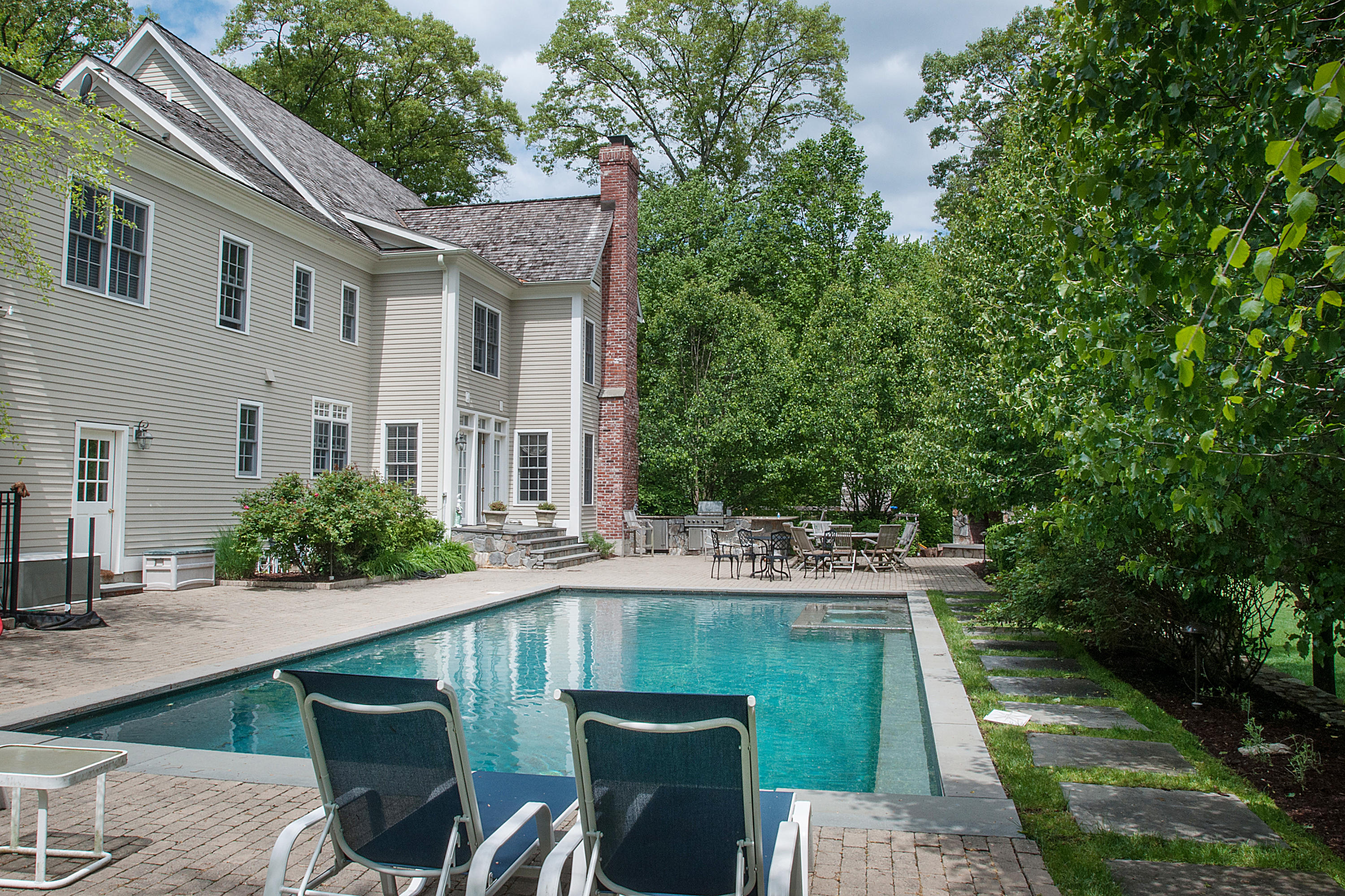550 Brookside Road New Canaan, CT 06840 - Photo 29 of 32 a patio with table and chairs
