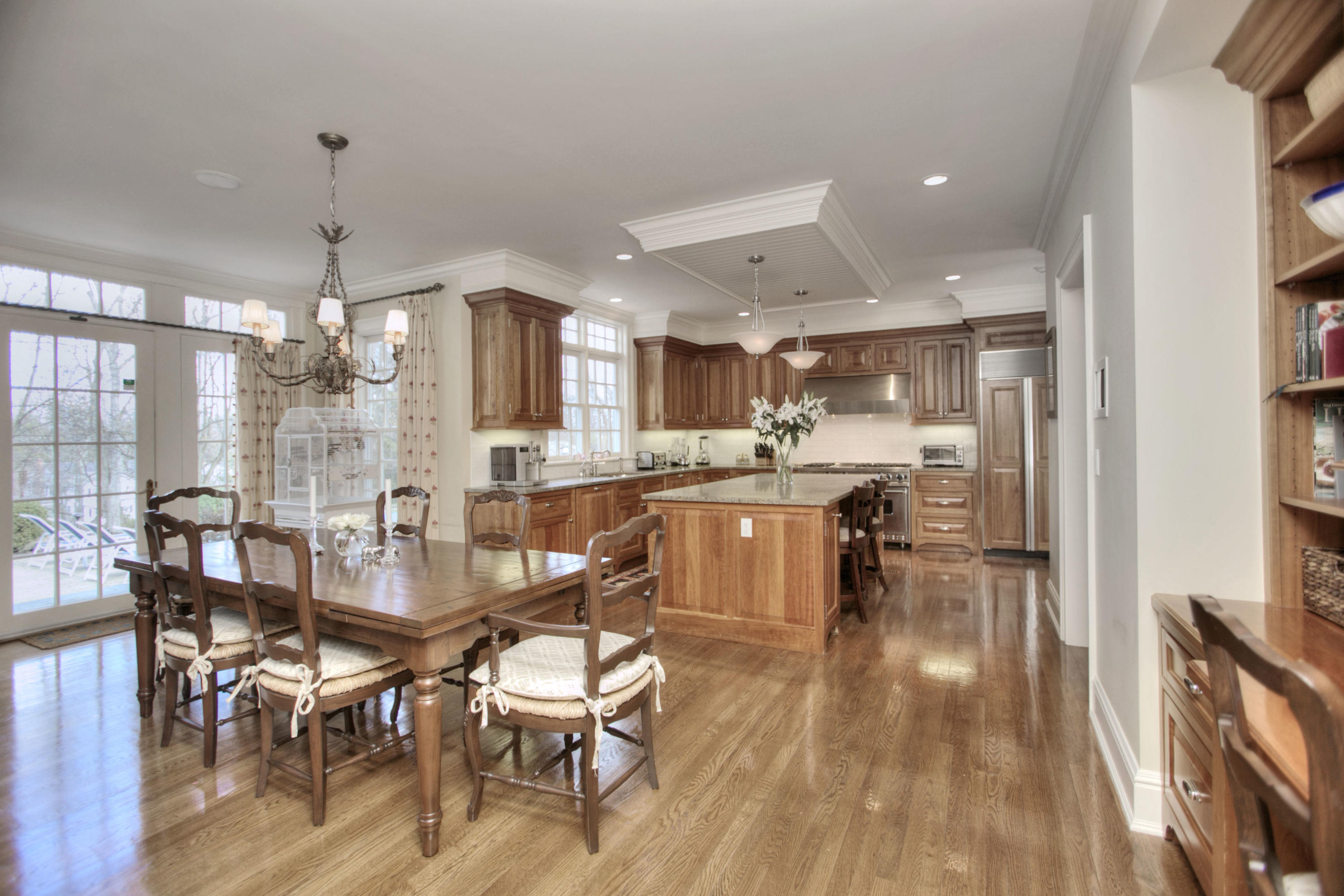 550 Brookside Road New Canaan, CT 06840 - Photo 9 of 32 a view of a dining room and livingroom with furniture wooden floor a chandelier