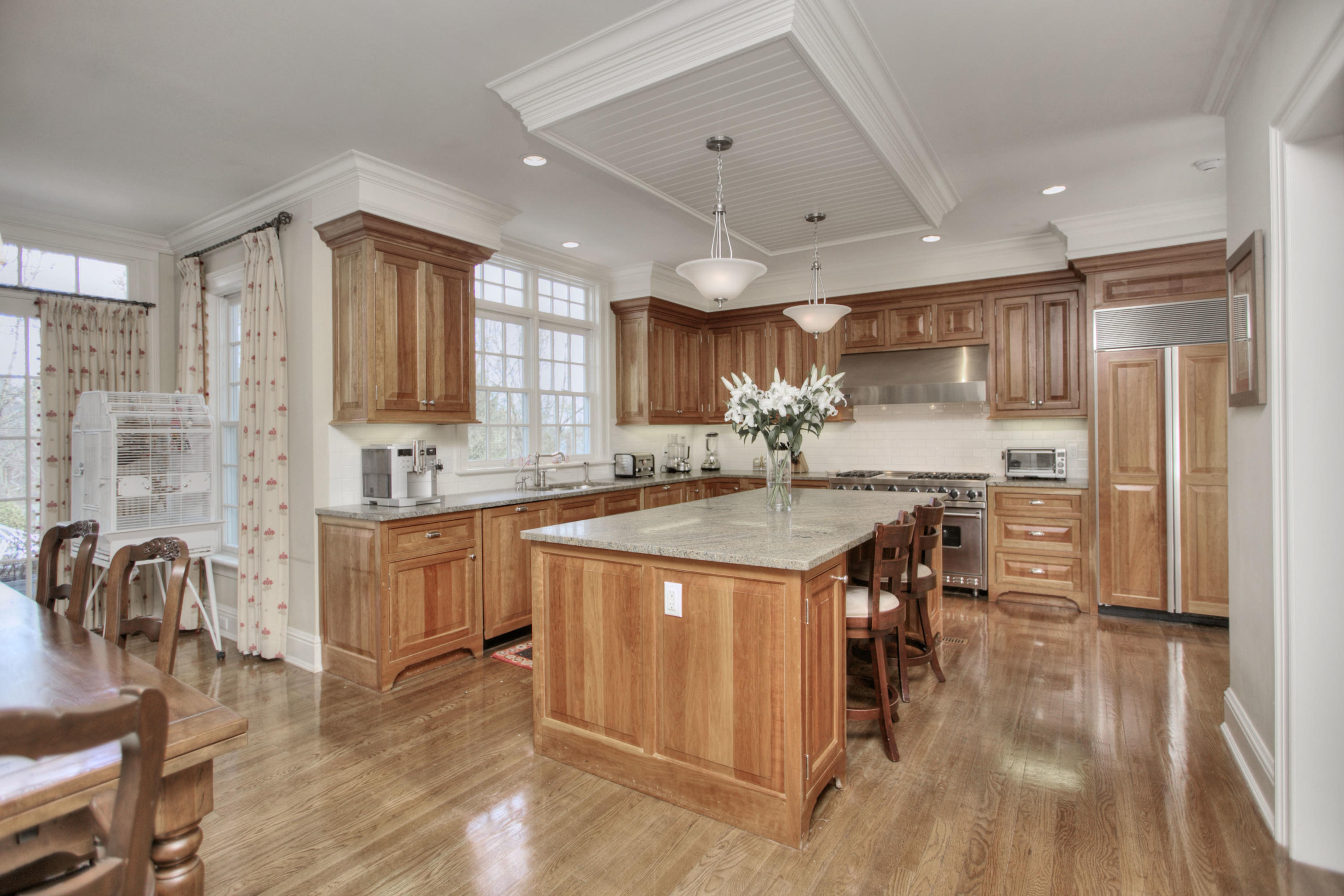 550 Brookside Road New Canaan, CT 06840 - Photo 10 of 32 a kitchen with stainless steel appliances granite countertop a refrigerator a sink a stove and white cabinets with wooden floor