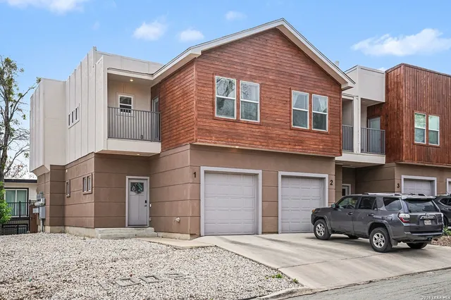 a car parked in front of a brick house