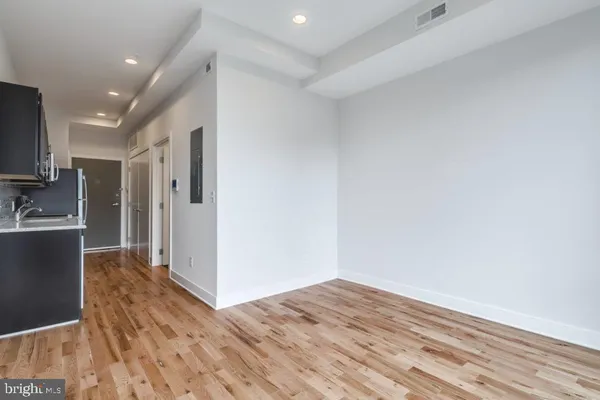 a view of kitchen with furniture and wooden floor