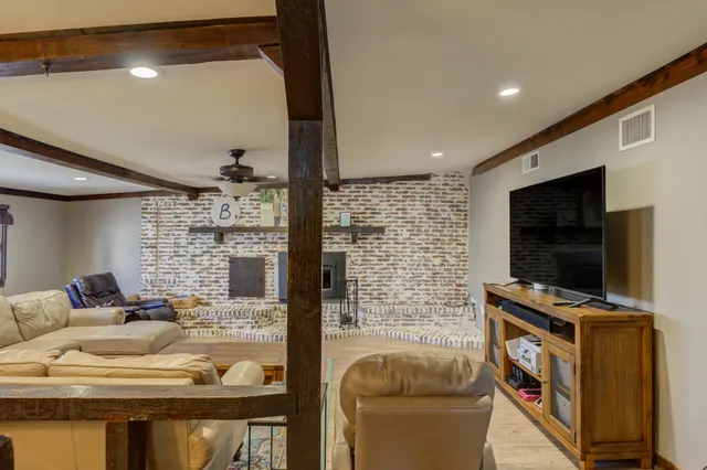 a living room with a large bed and a chandelier