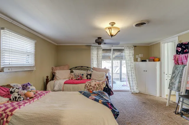 a bedroom with two beds and a window