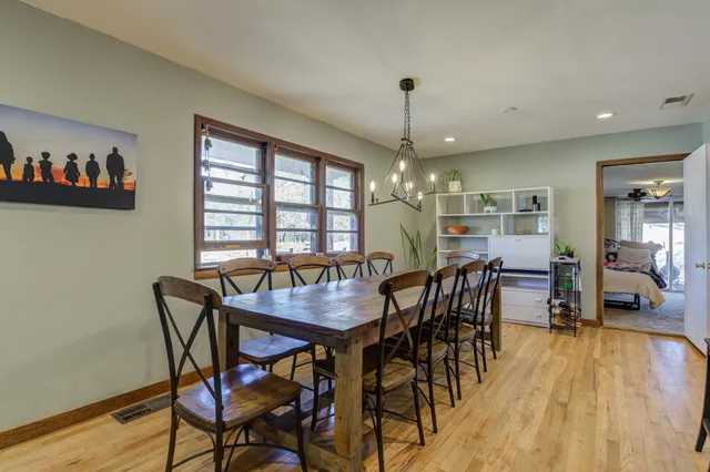 a view of a dining room with furniture window and wooden floor