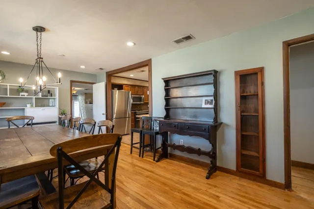 a view of a dining room with furniture and wooden floor
