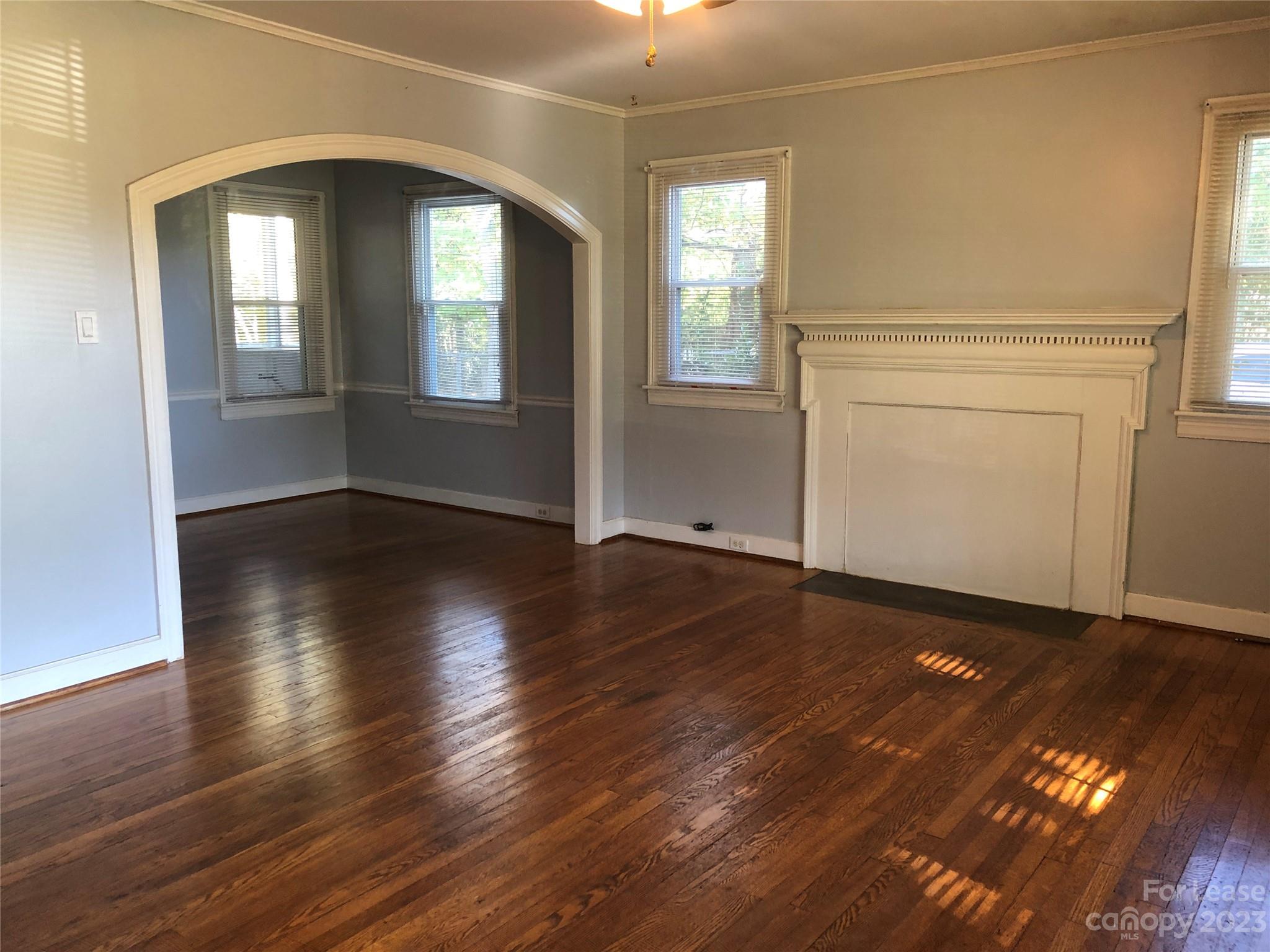 3200 Sam Wilson Road Charlotte, NC 28214 - Photo 2 of 13 an empty room with wooden floor and windows
