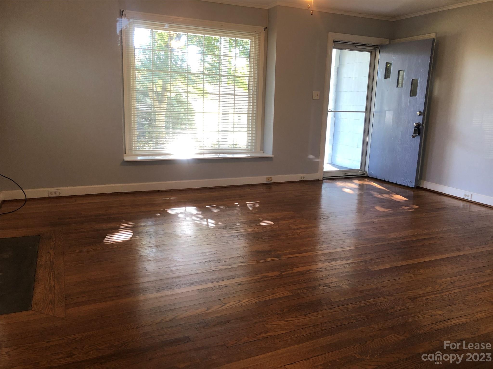 3200 Sam Wilson Road Charlotte, NC 28214 - Photo 3 of 13 a view of empty room with wooden floor and fan