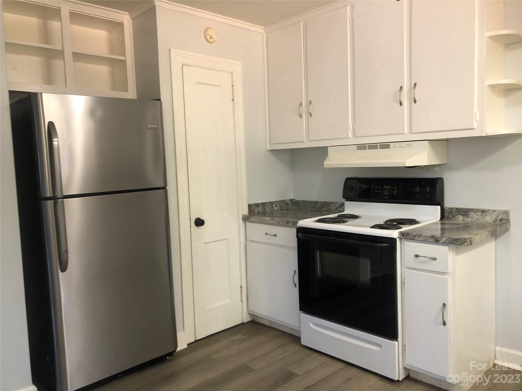 3200 Sam Wilson Road Charlotte, NC 28214 - Photo 5 of 13 a stove top oven sitting inside of a kitchen